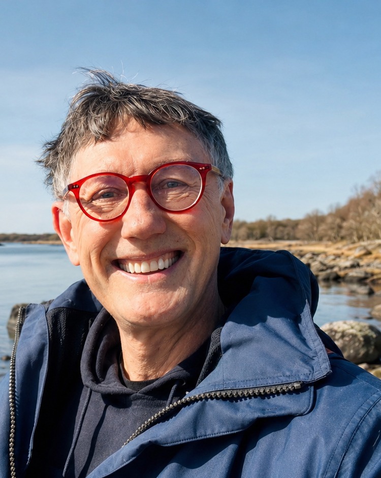 Hans Hirschi smiling by the water on the west coast
